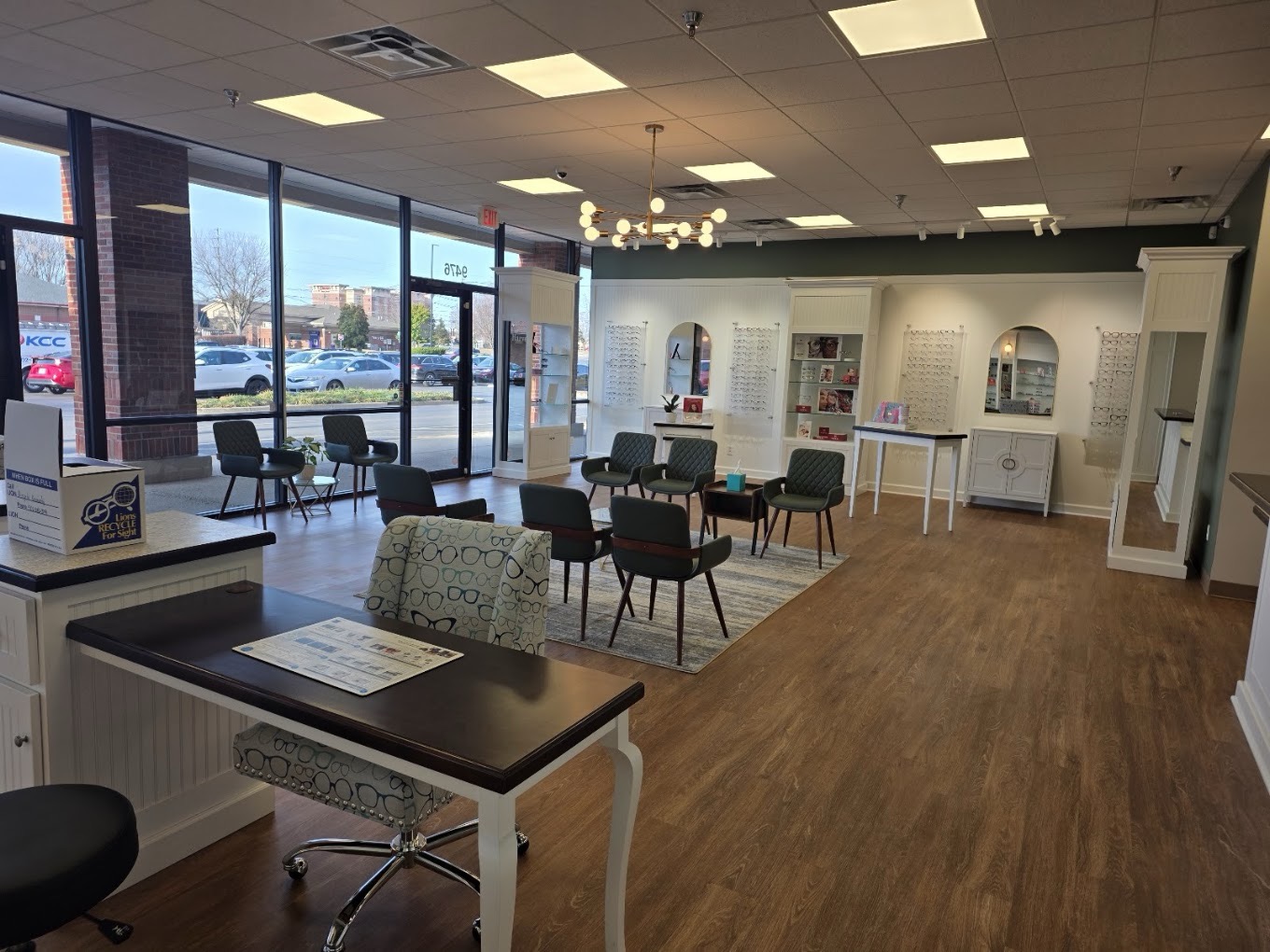 Sunlit waiting area with mid-century chairs and street-facing windows at Harvey Eye Brownsboro Road