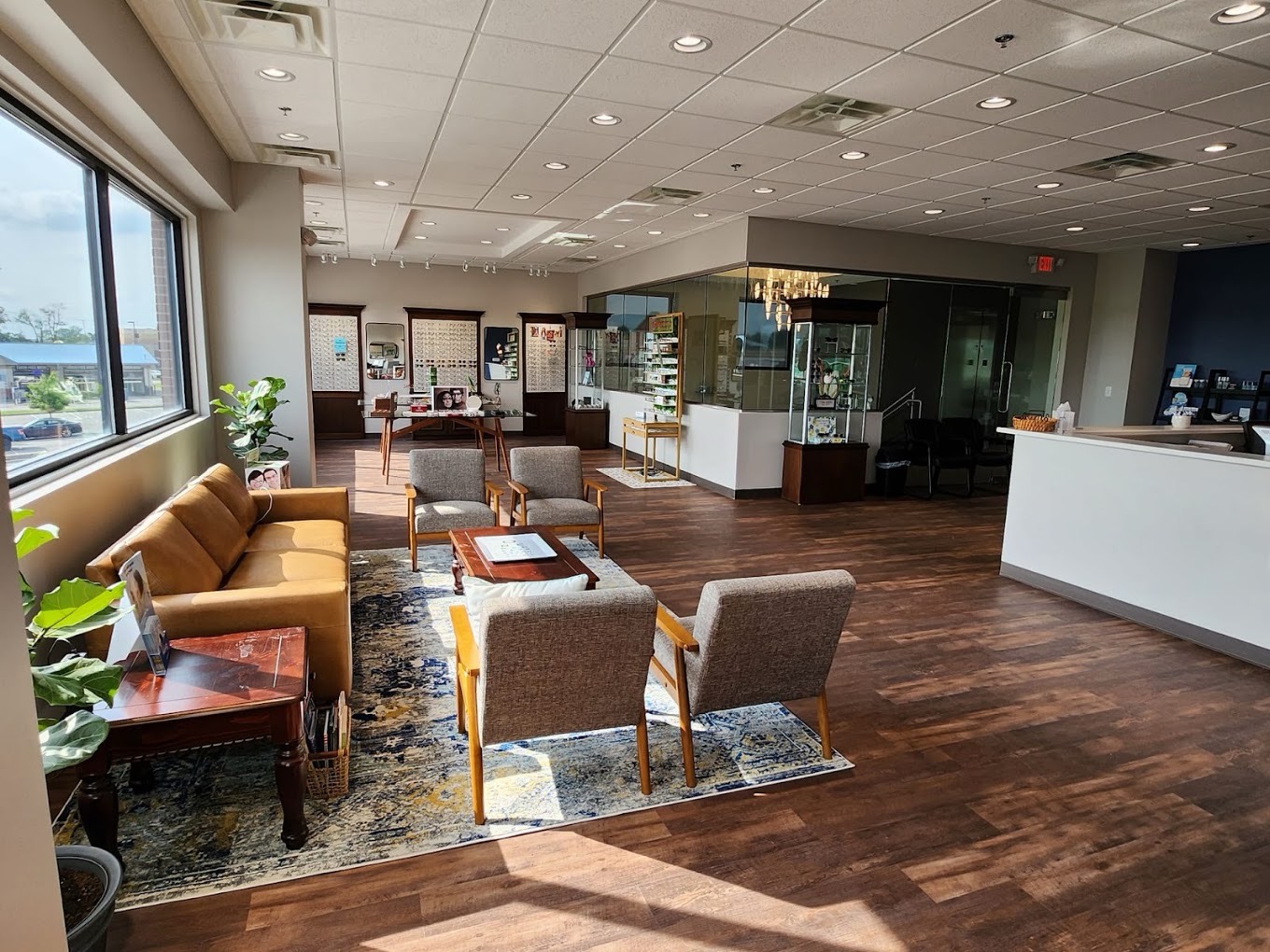 Waiting area with leather sofa, mid-century chairs, and frame boards at Harvey Eye LaGrange Road